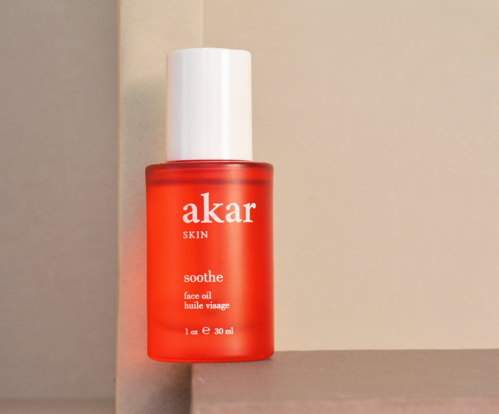 Akar Skin, Soothe Face Oil, skincare product, red bottle, glass, lifestyle photography, clean beauty